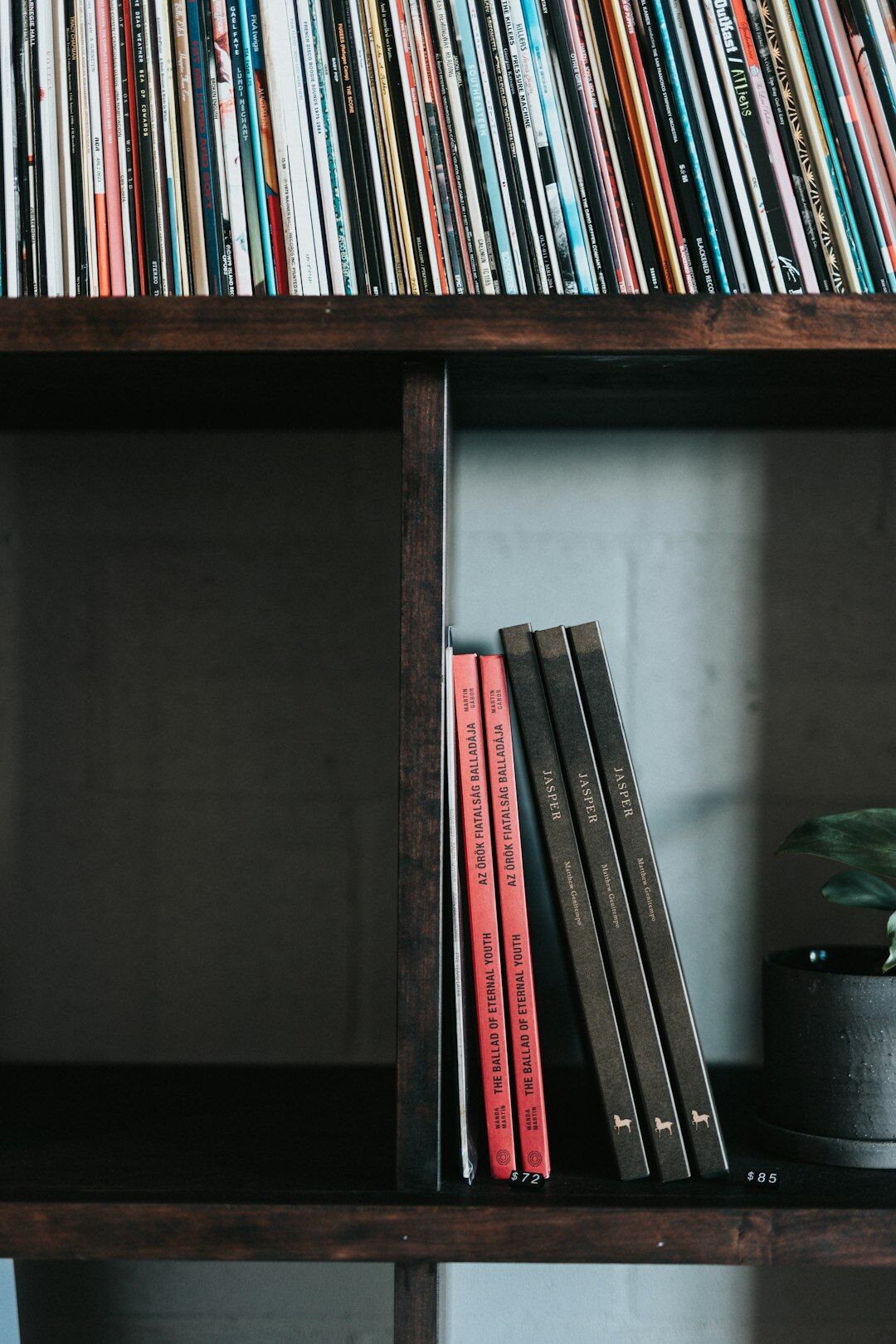 Stacked vintage magazines and archive boxes on a shelf